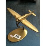 A brass desk weight in the form of a spitfire plan