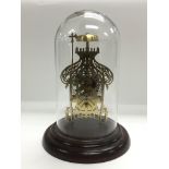 A brass skeleton clock under a glass dome, approx