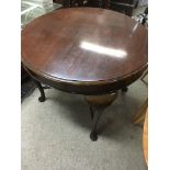 A circular mahogany occasional table on cabriole l