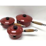 Three red vintage le creuset sauce pans in three v