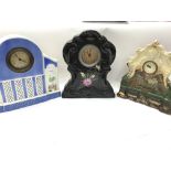 Three ceramic mantle clocks.