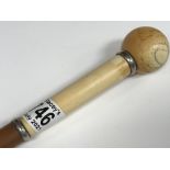 A Victorian walking stick with ivory handle and br