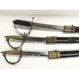 Three Indian swords and sheaths.