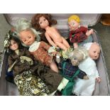 A suite case containing toy dolls various