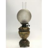 A Victorian oil lamp with a ceramic reservoir deco