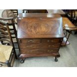 An Edwardian walnut drop front bureau with ball an