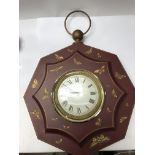 A vintage painted wall clock decorated with gold b
