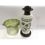 A milk glass oil lamp with decoration of fruiting