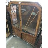 A walnut Art Deco style display cabinet fitted wit