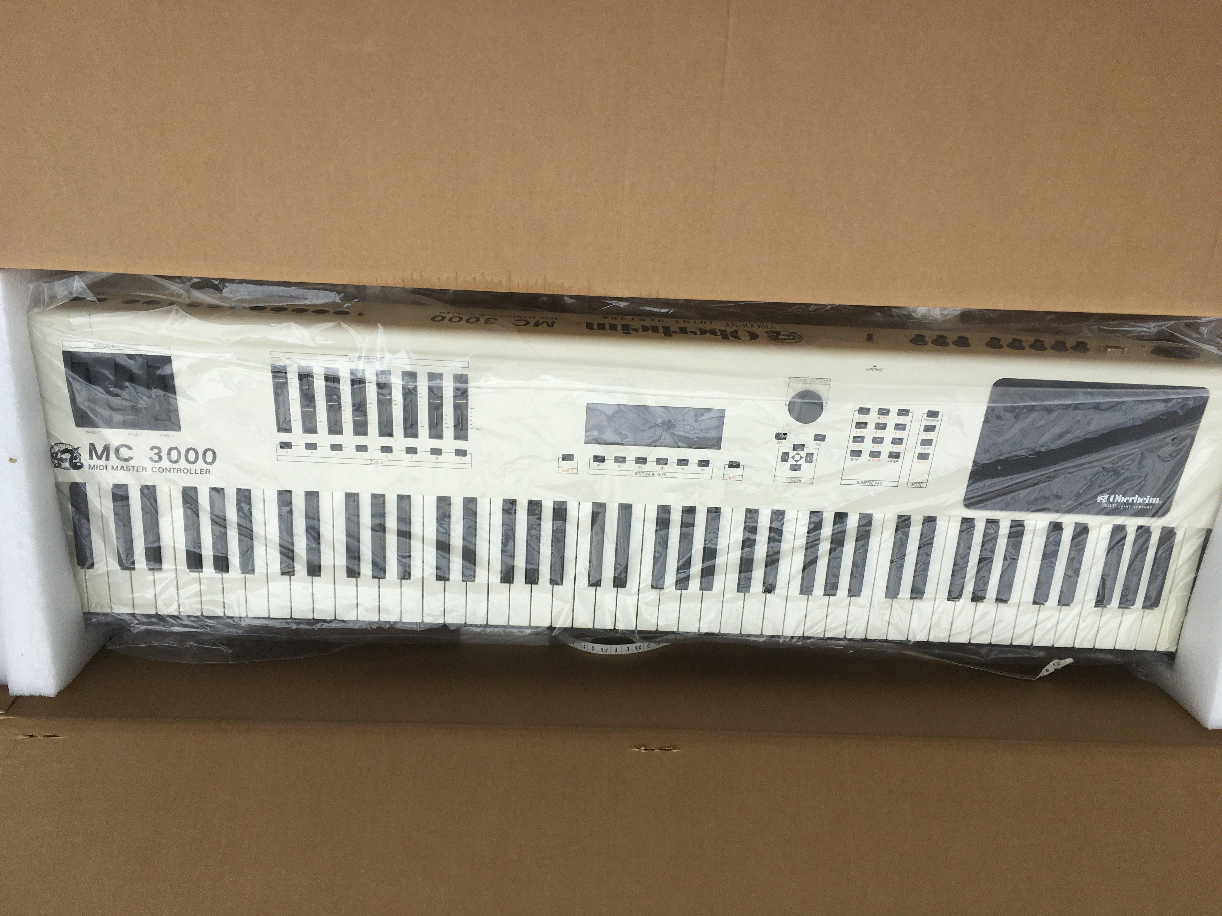 A boxed Oberheim MC3000 midi controller keyboard.