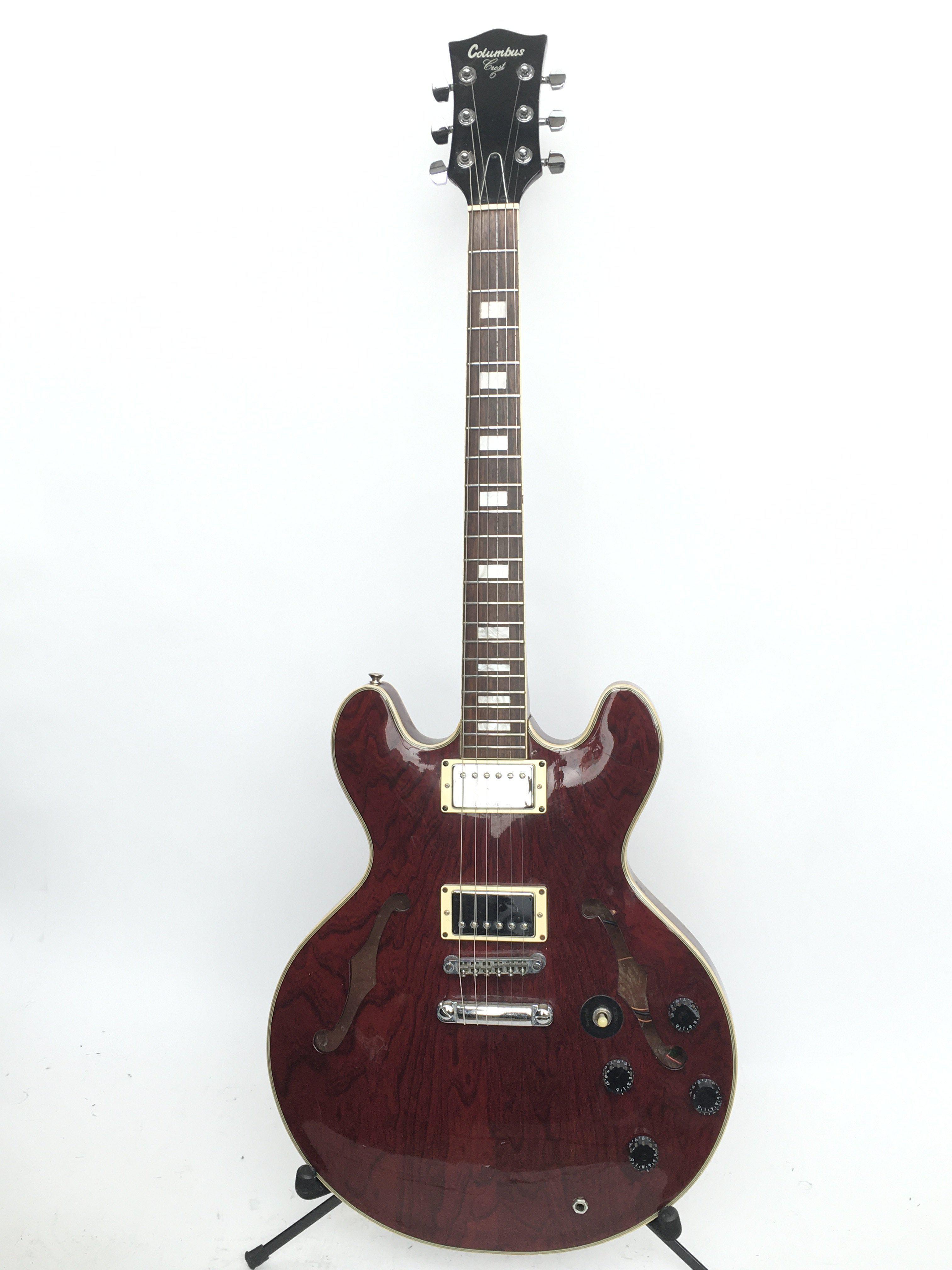 A Columbus 335 style electric guitar in wine red.