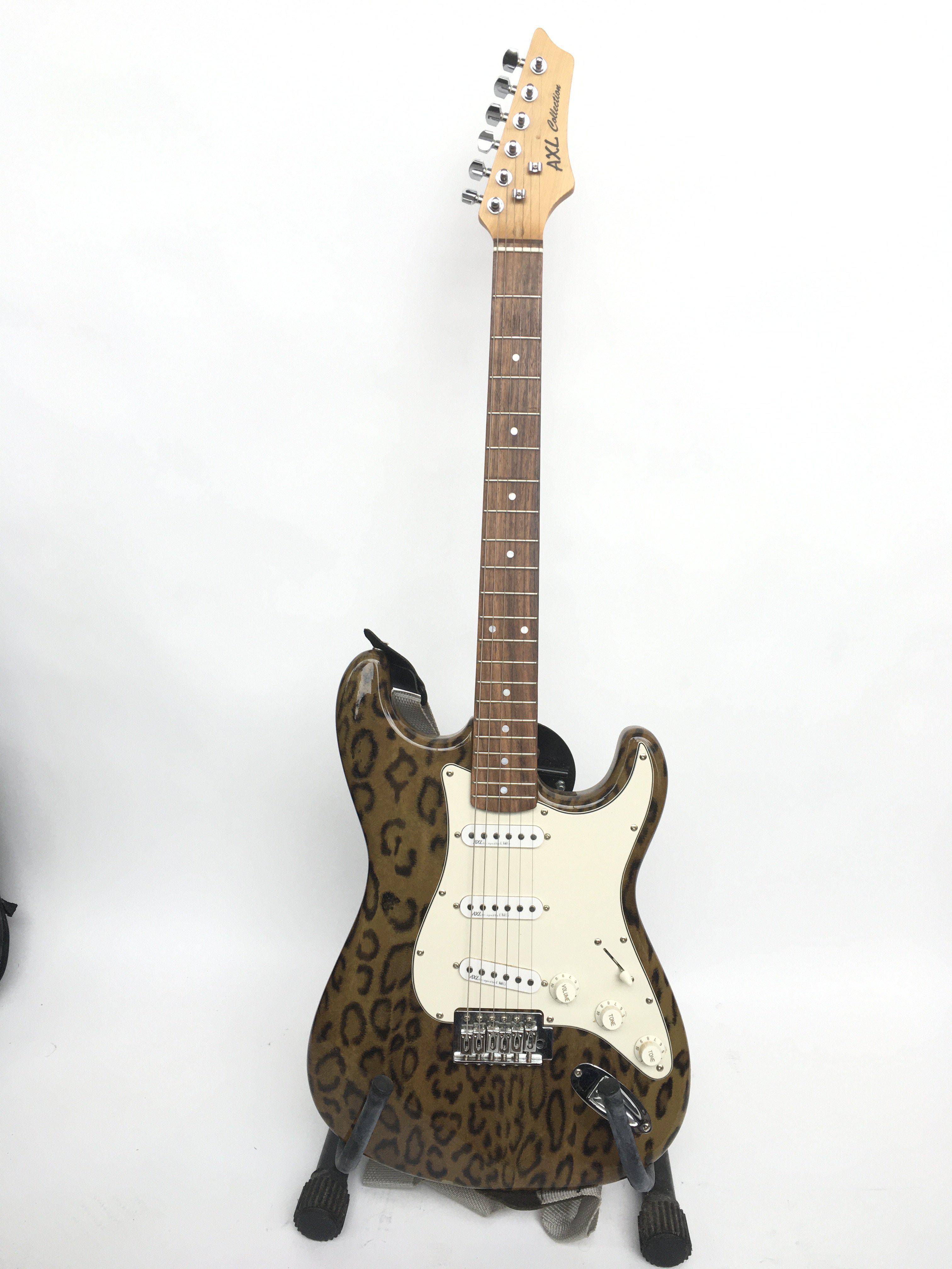 An AXL Strat style electric guitar with leopard pr