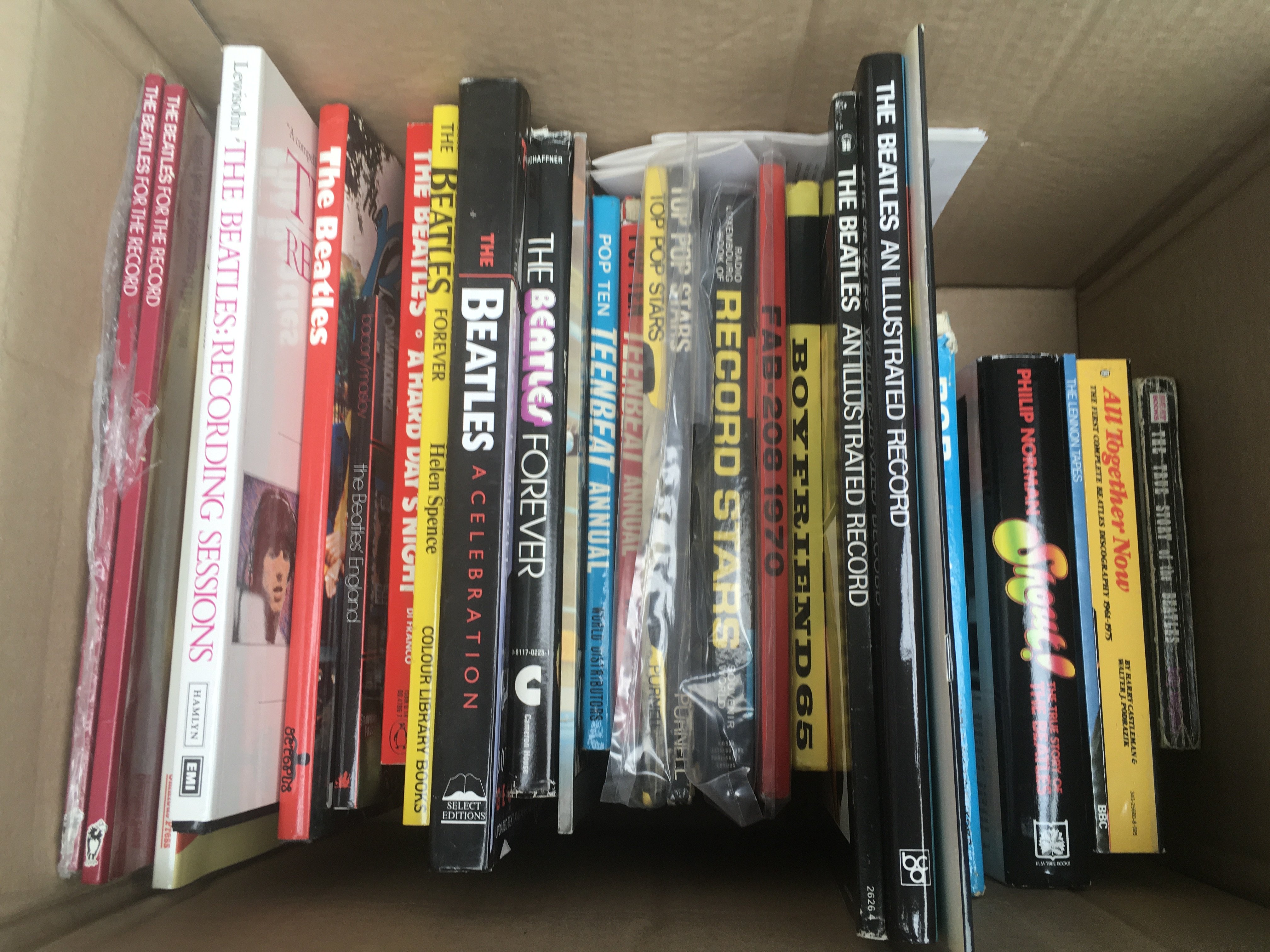 A box of Beatles and 60s pop music books.