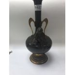 A bronzed Victorian style vase surmounted with a c