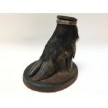 An antique boars foot table snuff mull on a wooden