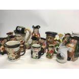 A collection of caricature jugs and Toby jugs and