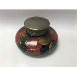 A Moorcroft inkwell with pewter lid decorated in t