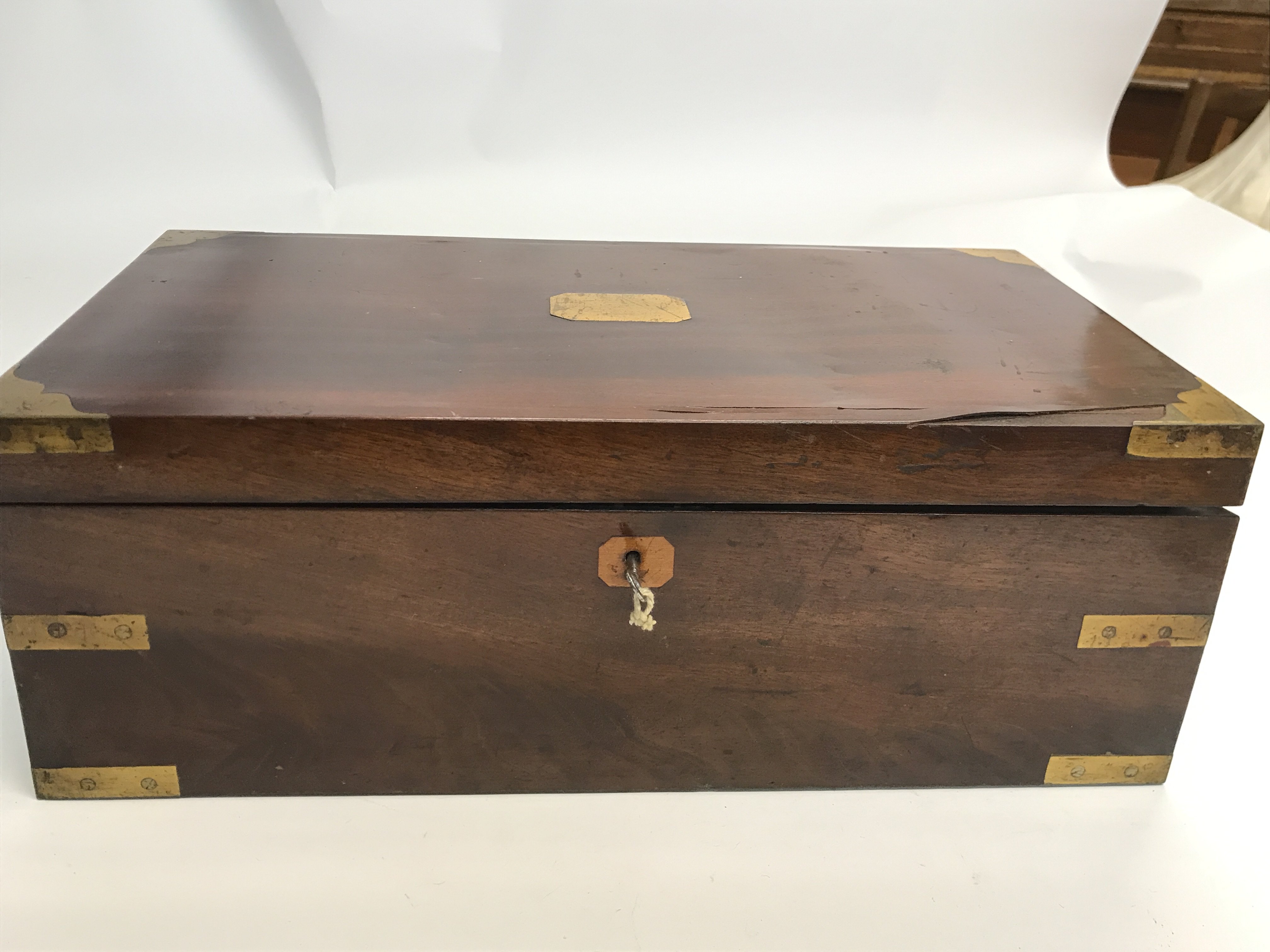 A large sloped walnut and brass bound writing box
