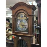 A walnut long case clock with a brass dial and bra