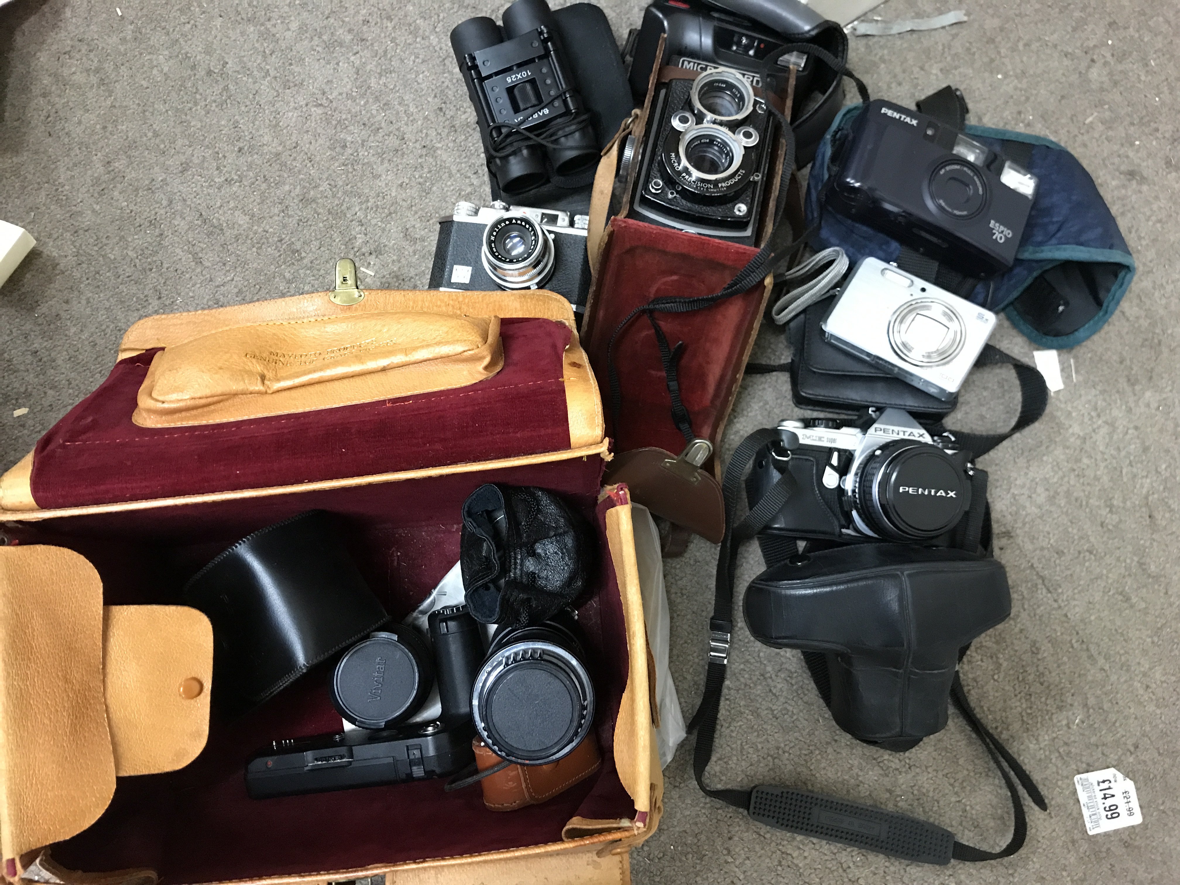 A collection of cameras including Pentax with thre