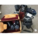 A collection of cameras including Pentax with thre