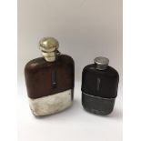 Two vintage leather and pewter hip flasks.