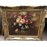 A framed still life study depicting flowers, signe