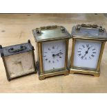 Three carriage clocks, two with Roman numerals.