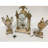 A gilt metal and marble clock garniture with sunbu