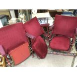 Three old cinema seats with red fabric upholstery.