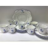 A Edwardian tea set decorated with blue flowers. Including cups saucers sandwich plate .