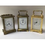 Three carriage clocks, one That is cased.