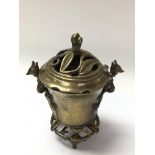 An old Chinese brass incense burner with lid and s