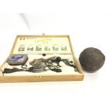 An Antique canon ball and a box containing metal d