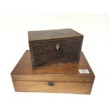 A George III mahogany and boxed inlay tea caddy with a hinged top enclosing two compartments and a
