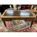 A Victorian mahogany desk with reeded legs and leather insert top.