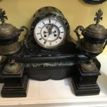 A Victorian slate mantle clock with visible escape