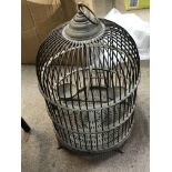 A vintage brass bird cage with ring for hanging. I