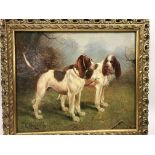 A framed oil on canvas depicting two blood hounds