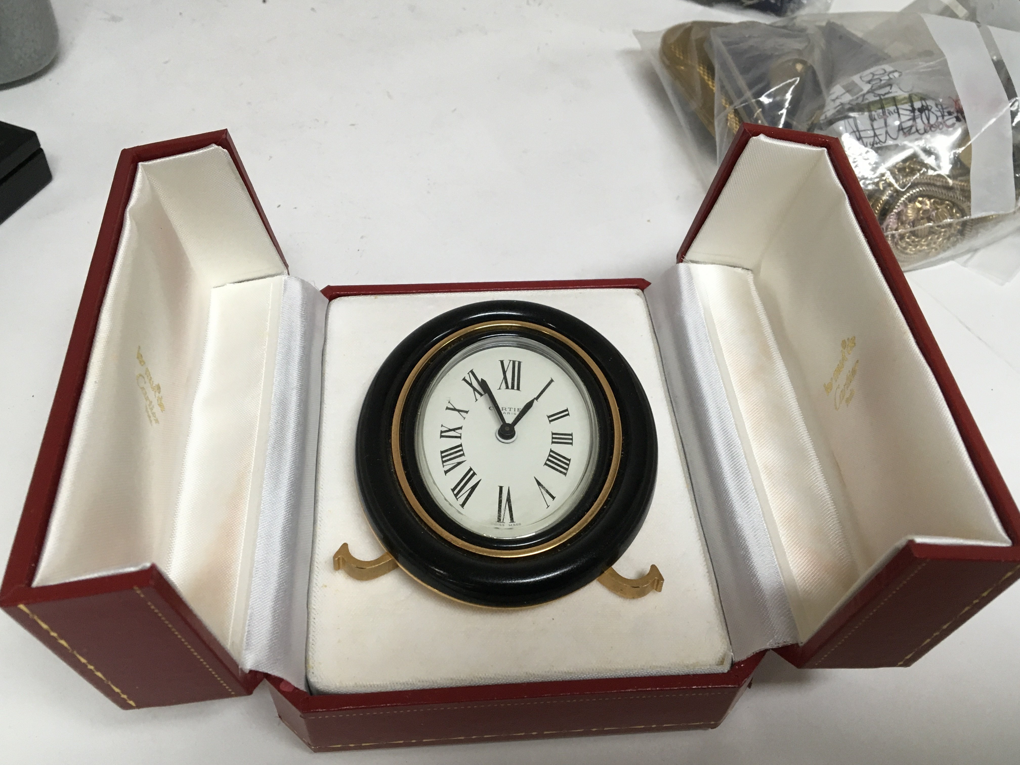 A Cartier traveling alarm clock on an Easel gilt metal stand oval dial manual wind seen working - Image 3 of 3