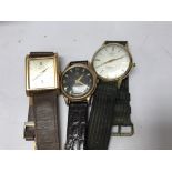 A collection of three dress watches .