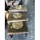 A nest of tables with map tops