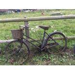 A Vintage trade bike featuring a bell and pump wit