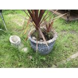 A large stone flower pot and concrete boot