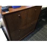 A modern teak chest of drawers fitted with cupboards above drawers. 90x32cm