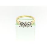 An 18ct gold princess cur diamond ring. Diamonds a