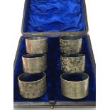 A set of six silver plated napkin rings, cased.