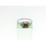 An 18ct white gold fancy brown cushion cut diamond