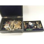 A leather box containing costume jewellery.