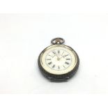 An antique silver fob watch with an enamel dial.